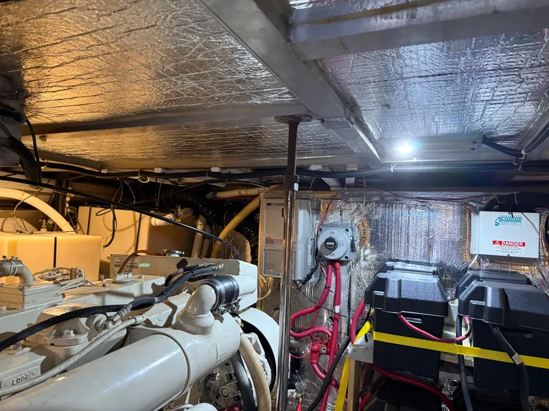 Slide: The Image of Engine room of a 1998 Carver 530 VOYAGER yacht, featuring machinery and wiring. - 12