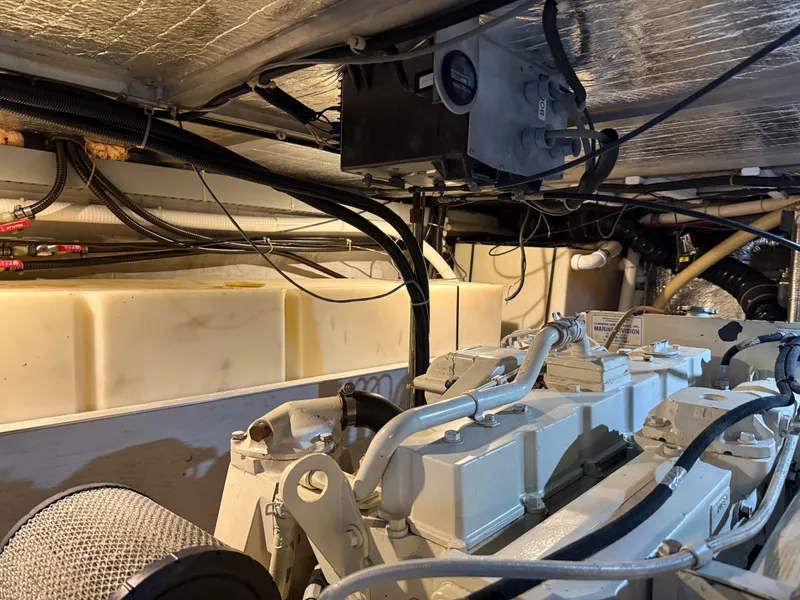 Slide: The Image of Engine room of 1998 Carver 530 VOYAGER yacht, showcasing mechanical components and wiring. - 15