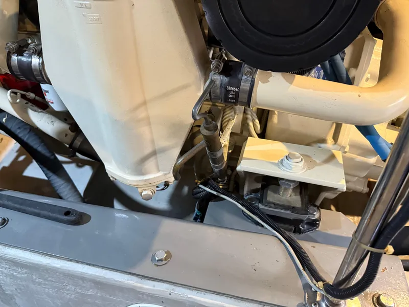 Slide: The Image of Engine components of a 1998 Carver 530 VOYAGER yacht, showcasing hoses and mechanical parts. - 18