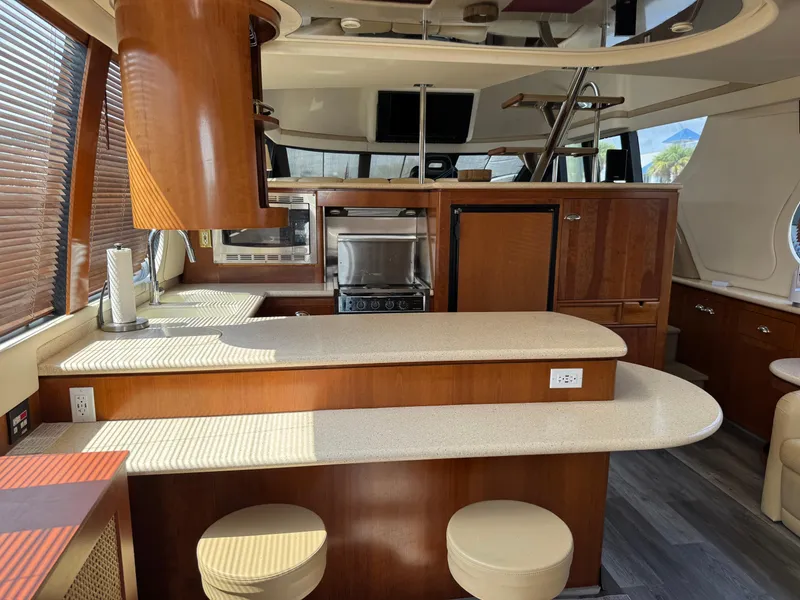 Slide: The Image of Interior of 1998 Carver 530 Voyager yacht with modern kitchen and seating area. - 2