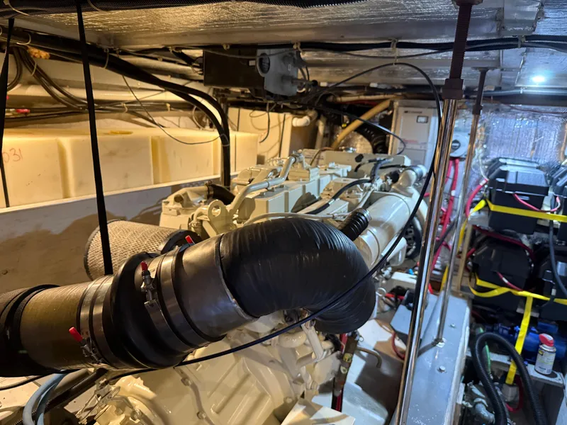 Slide: The Image of Engine room of a 1998 Carver 530 VOYAGER yacht, showcasing mechanical components and wiring. - 22