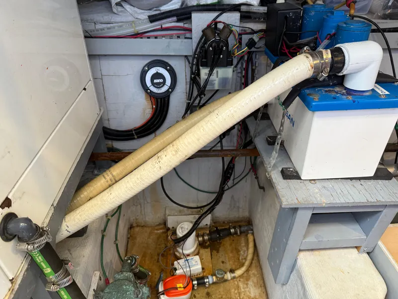 Slide: The Image of Engine room of a 1998 Carver 530 VOYAGER with visible hoses and equipment. - 24