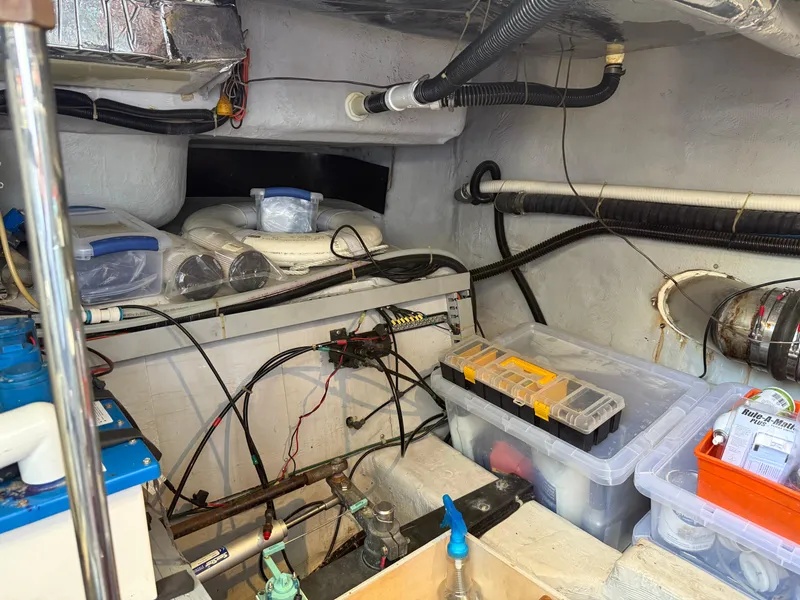 Slide: The Image of Engine room of a 1998 Carver 530 VOYAGER with storage boxes and wiring. - 25