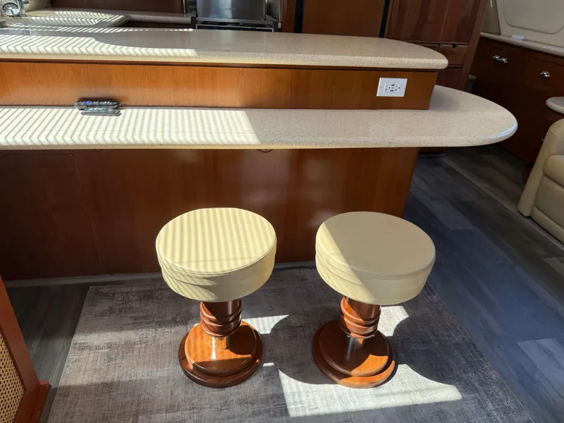 Slide: The Image of Interior of 1998 Carver 530 VOYAGER with two wooden stools and a countertop. - 27