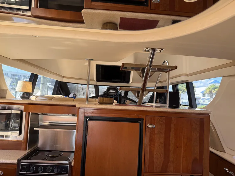 Slide: The Image of Interior of 1998 Carver 530 VOYAGER yacht with kitchen and helm area. - 28