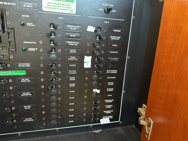 Slide: The Image of Electrical panel of a 1998 Carver 530 Voyager yacht with labeled switches and controls. - 29