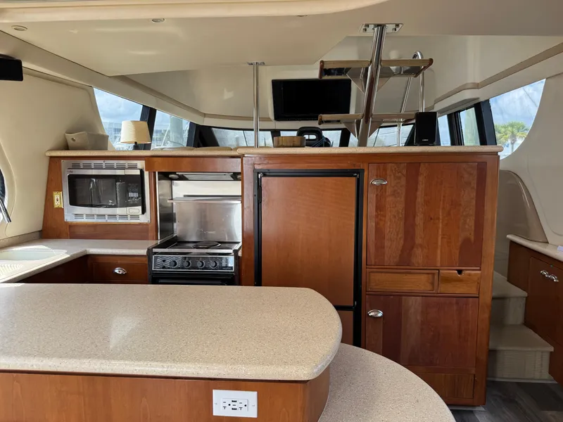 Slide: The Image of Interior of 1998 Carver 530 Voyager yacht with kitchen and wooden cabinetry. - 3