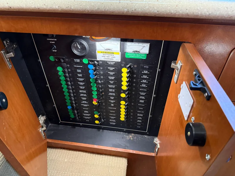 Slide: The Image of Electrical panel inside a 1998 Carver 530 VOYAGER yacht, featuring labeled switches and gauges. - 30