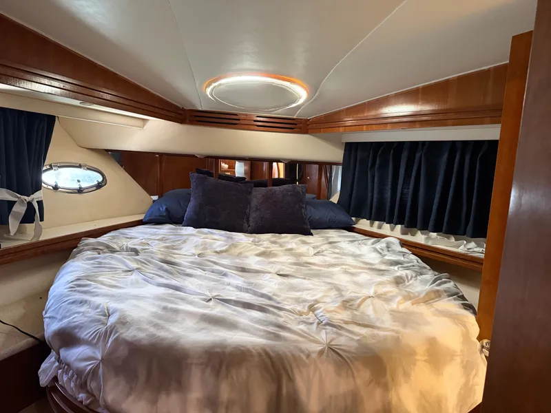 Slide: The Image of Luxurious bedroom interior of 1998 Carver 530 VOYAGER yacht with cozy bedding. - 32