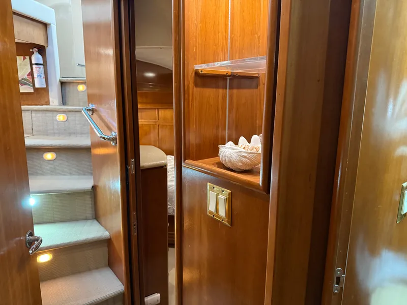 Slide: The Image of Interior of 1998 Carver 530 Voyager yacht with wooden cabinetry and carpeted stairs. - 35