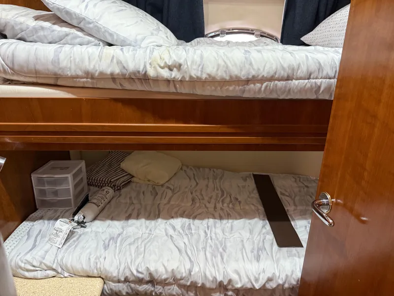Slide: The Image of Bunk beds inside a 1998 Carver 530 VOYAGER yacht cabin with wooden finishes. - 36