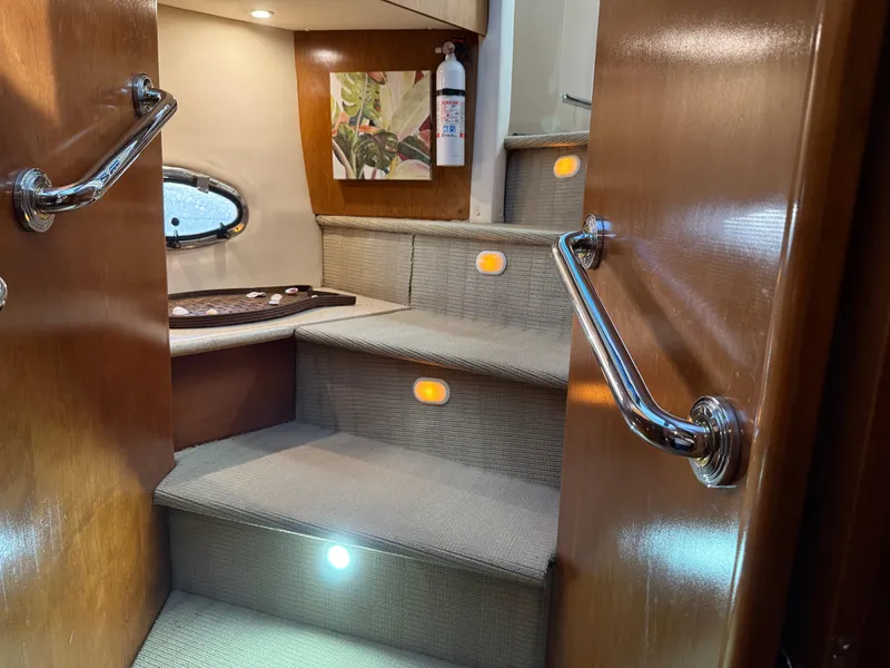Slide: The Image of Staircase inside 1998 Carver 530 VOYAGER yacht with elegant lighting and wooden handrails. - 37