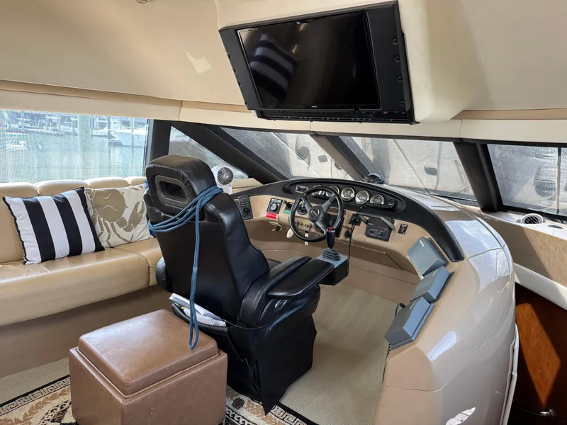 Slide: The Image of 1998 Carver 530 Voyager helm with leather seat, modern controls, and large windows. - 4