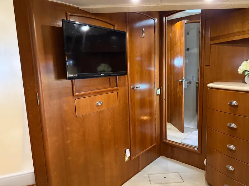 Slide: The Image of Interior of 1998 Carver 530 Voyager yacht with wood paneling and mounted TV. - 44