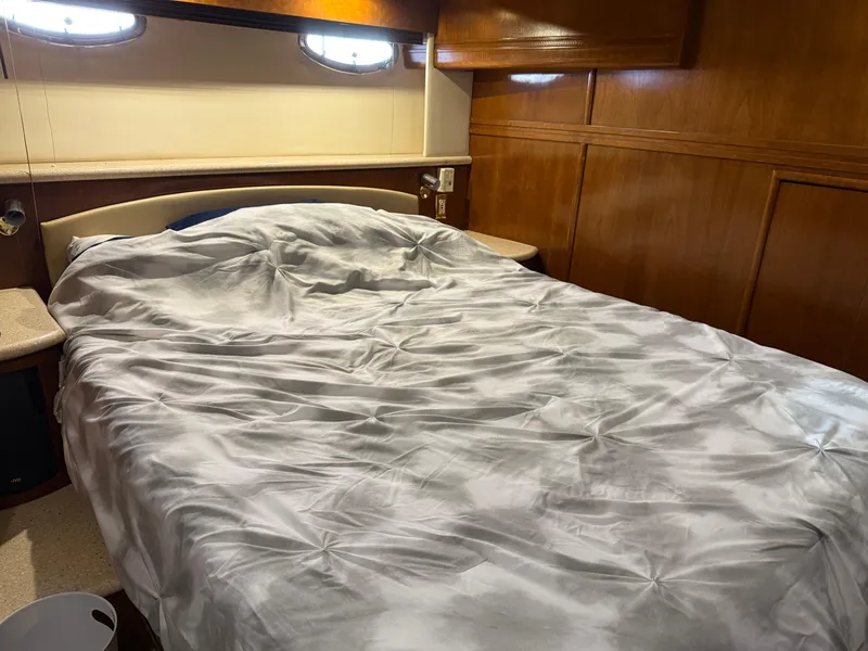 Slide: The Image of Cozy bedroom interior of 1998 Carver 530 Voyager yacht with wooden paneling. - 46