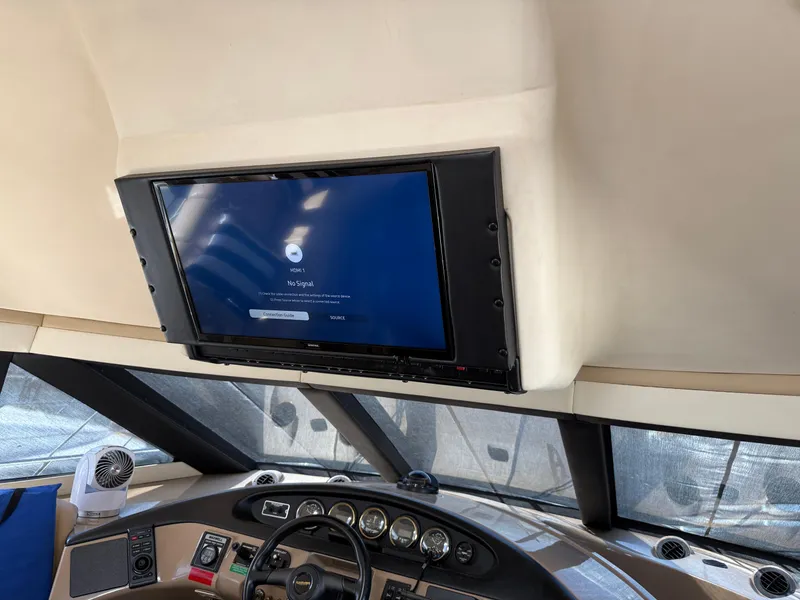 Slide: The Image of Interior of 1998 Carver 530 VOYAGER yacht with dashboard and mounted TV screen. - 47
