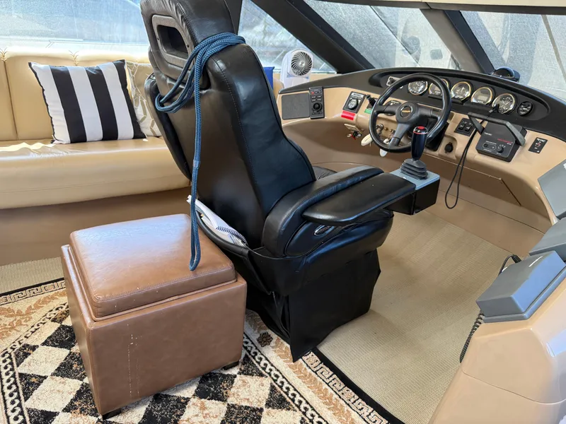 Slide: The Image of 1998 Carver 530 Voyager helm with leather seat, control panel, and nautical decor. - 48