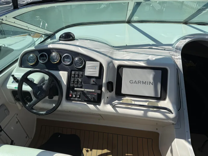 Slide: The Image of 1998 Carver 530 Voyager helm with Garmin navigation system and control panel. - 49