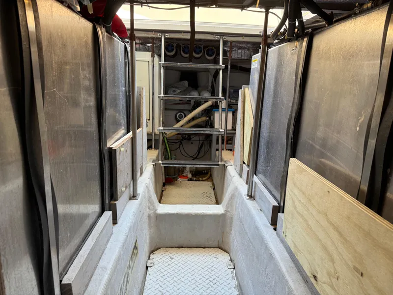 Slide: The Image of Engine room of 1998 Carver 530 VOYAGER yacht with visible equipment and access ladder. - 8