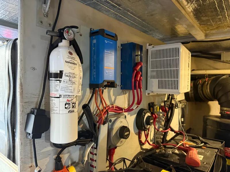 Slide: The Image of Electrical setup in a 1998 Carver 530 VOYAGER with fire extinguisher and wiring components. - 9