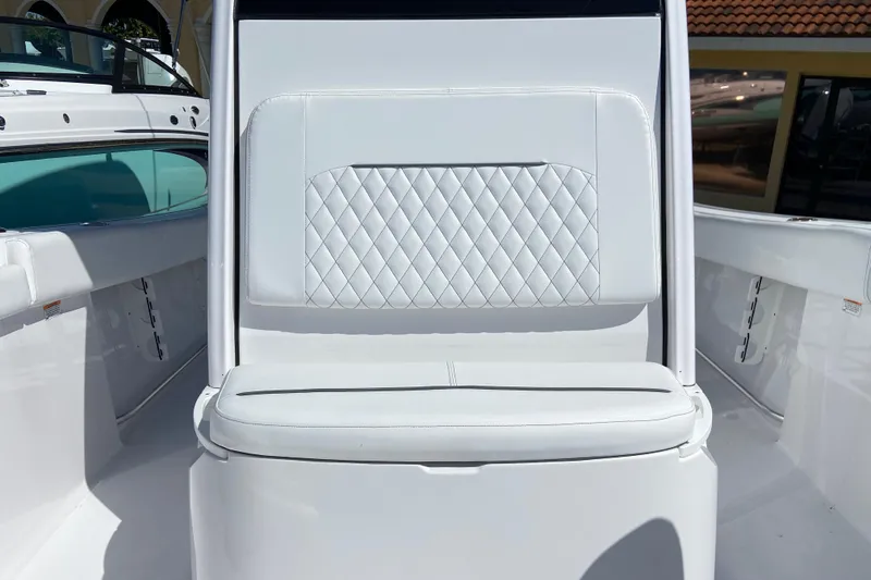 Slide: The Image of 2025 Sportsman Open 212 Center Console boat interior with white cushioned seating. - 24