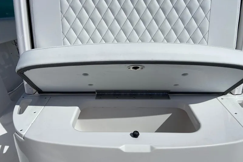 Slide: The Image of 2025 Sportsman Open 212 Center Console seat with storage compartment open. - 25