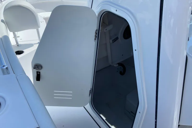 Slide: The Image of 2025 Sportsman Open 212 Center Console boat with open storage compartment. - 28
