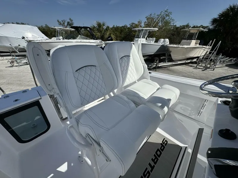 Slide: The Image of 2025 Sportsman 212 Open boat with white cushioned seating and steering wheel. - 8