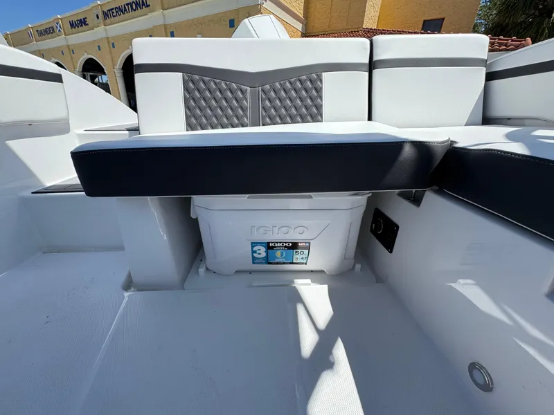 Slide: The Image of 2024 Monterey M225 boat interior with cushioned seating and Igloo cooler storage. - 5