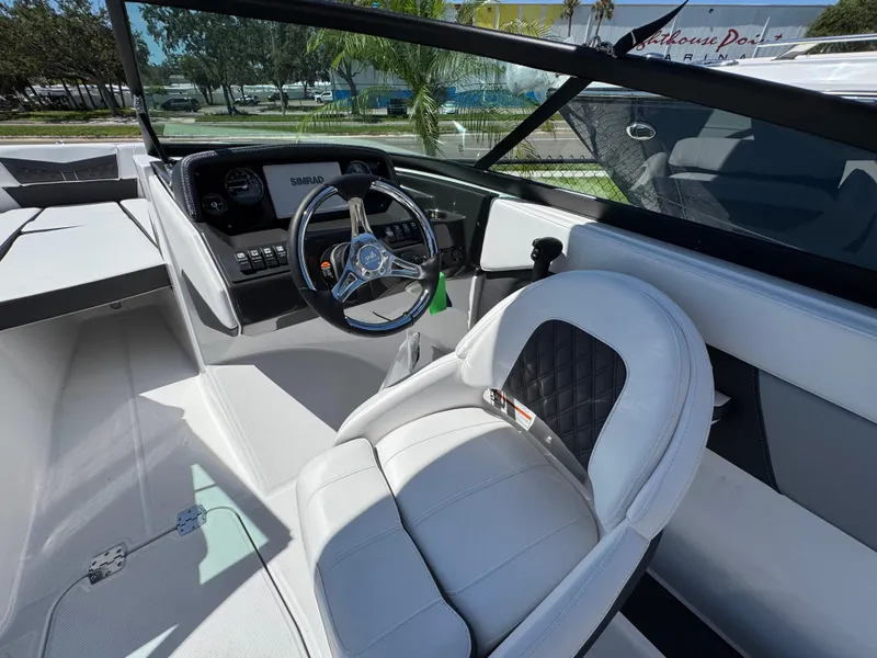 Slide: The Image of 2024 Monterey M225 boat interior with steering wheel and white seating. - 6