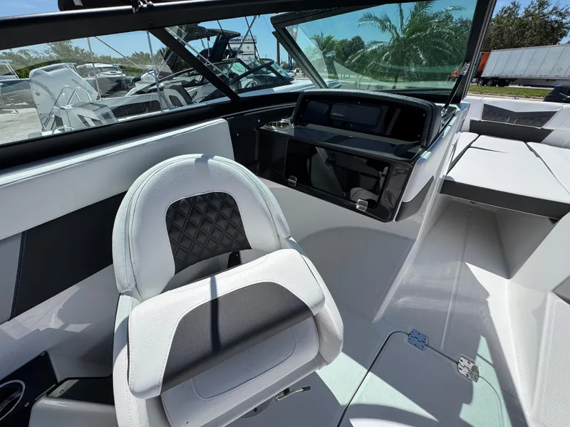 Slide: The Image of 2024 Monterey M225 boat interior with modern seating and dashboard, showcasing sleek design. - 8