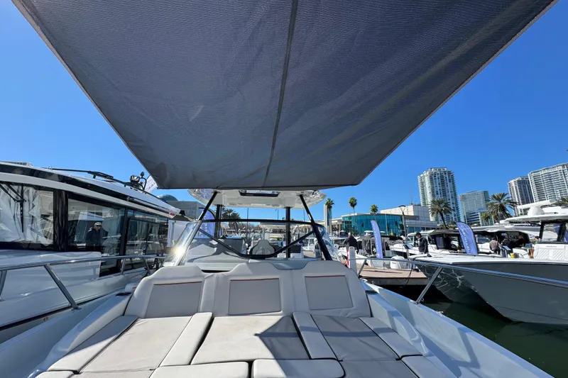 Slide: The Image of 2024 Jeanneau Leader 9.0 WA Series 2 boat with sunshade, docked in marina. - 17