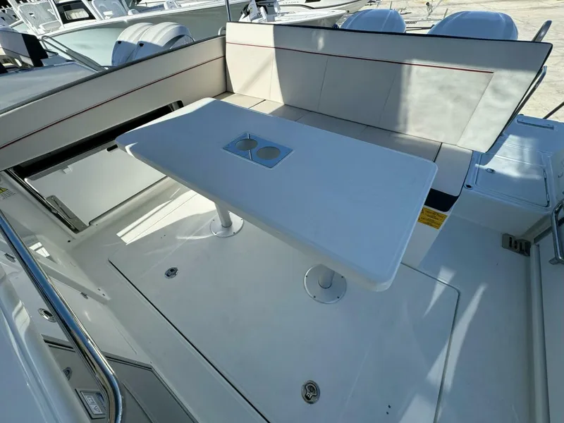 Slide: The Image of 2024 Jeanneau Leader 9.0 WA Series 2 boat interior with seating and table. - 4