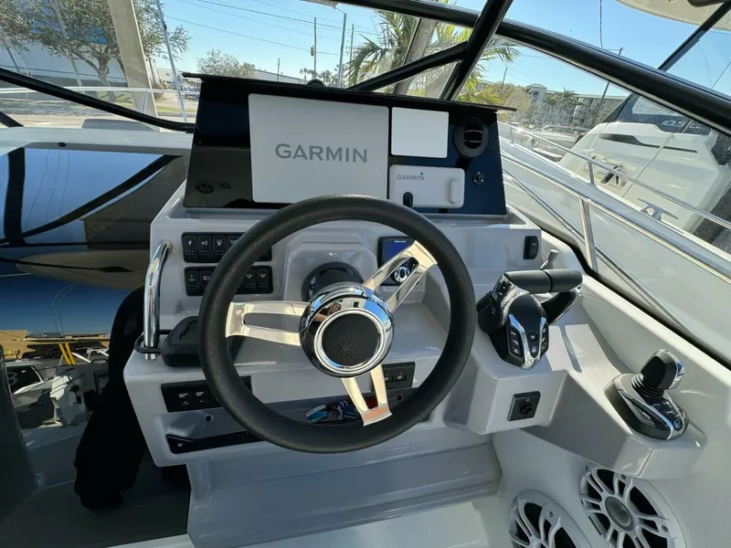 Slide: The Image of 2024 Jeanneau Leader 9.0 WA Series 2 cockpit with modern helm and seating. - 6