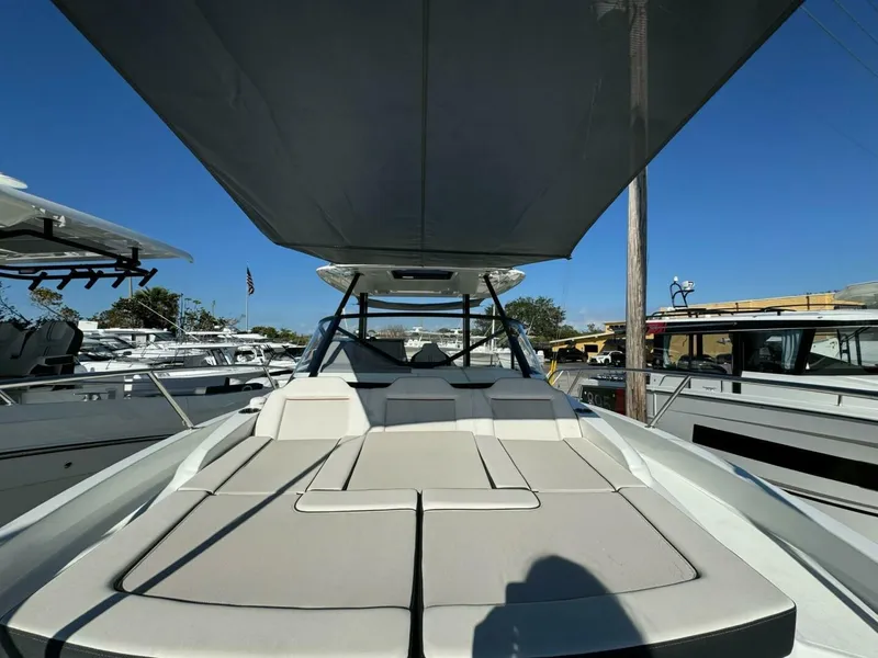 Slide: The Image of 2024 Jeanneau Leader 9.0 WA Series 2 boat seats, white and black, at a marina. - 8