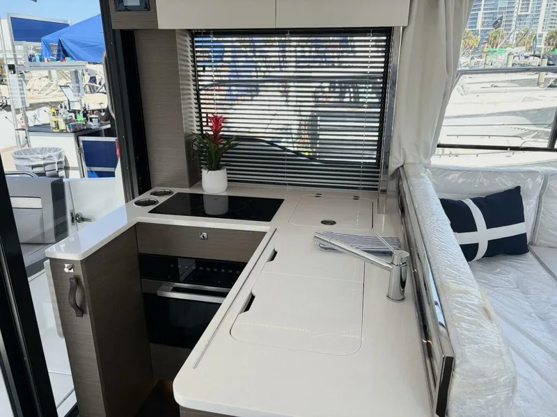 Slide: The Image of Modern kitchen area on 2025 Jeanneau 1295 FLY yacht with sleek design and appliances. - 14