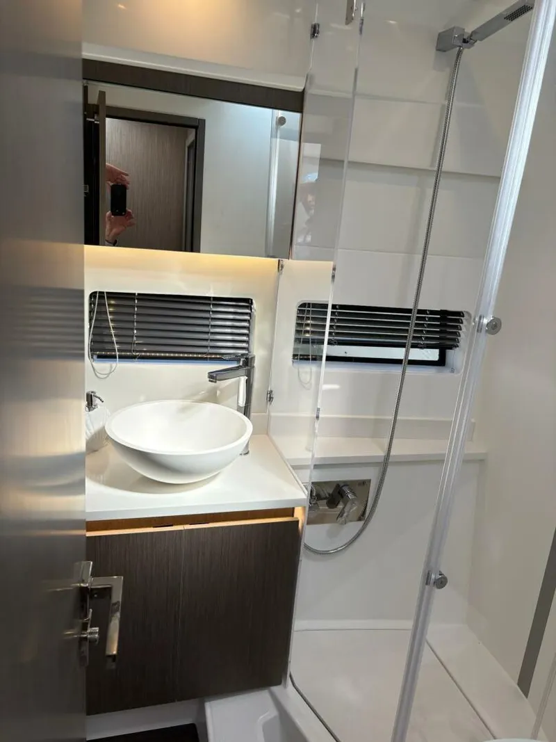 Slide: The Image of Modern bathroom in 2025 Jeanneau 1295 FLY yacht with sleek fixtures and glass shower. - 23