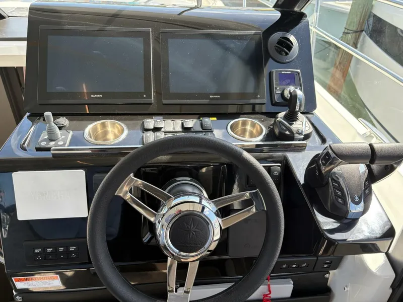 Slide: The Image of Helm of 2025 Jeanneau 1295 FLY yacht with dual Garmin displays and Yamaha controls. - 7