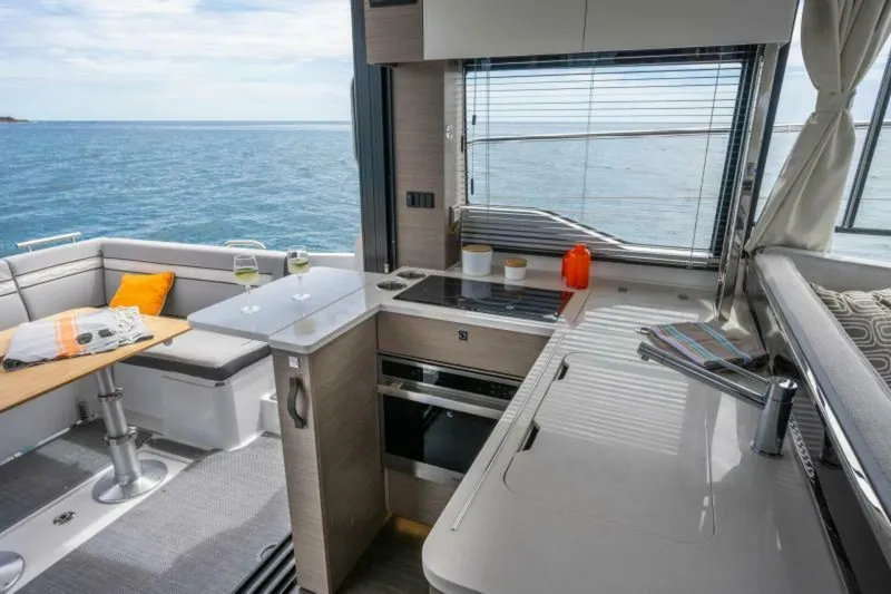 Slide: The Image of Interior of 2025 Jeanneau 1295 FLY yacht with modern kitchen and ocean view. - 17