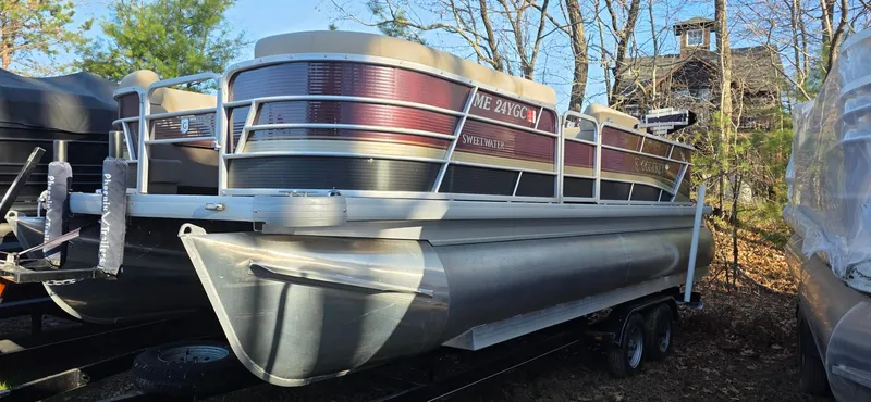 Slide: The Image of 2022 Godfrey Sweetwater 2286 FS pontoon boat parked outdoors in wooded area. - 0