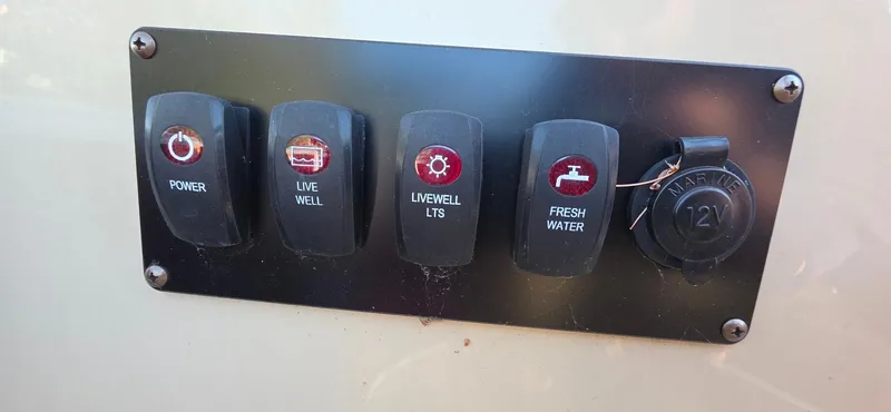 Slide: The Image of Control panel of a 2022 Godfrey Sweetwater 2286 FS boat with labeled switches. - 13