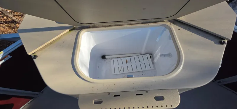 Slide: The Image of Open storage compartment on 2022 Godfrey Sweetwater 2286 FS boat. - 14