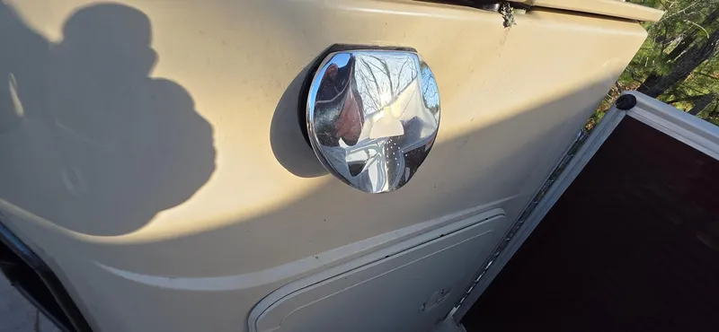 Slide: The Image of 2022 Godfrey Sweetwater 2286 FS boat detail with chrome fixture and beige exterior. - 16