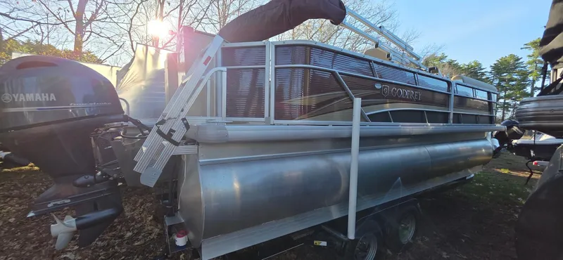 Slide: The Image of 2022 Godfrey Sweetwater 2286 FS pontoon boat with Yamaha outboard motor, parked on trailer. - 2