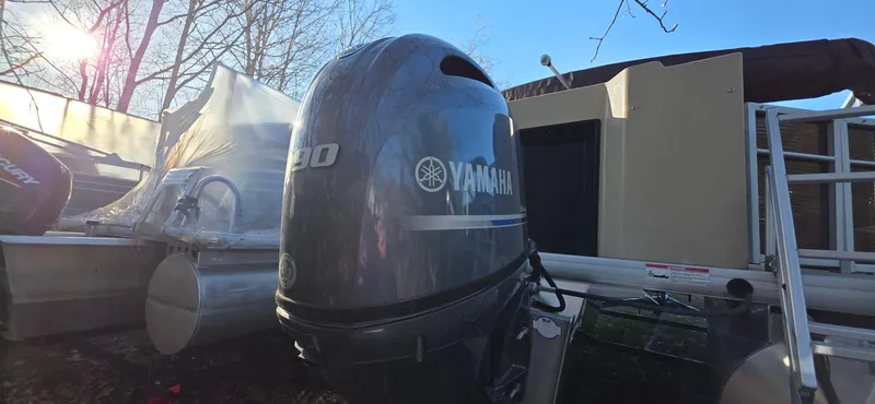 Slide: The Image of 2022 Godfrey Sweetwater 2286 FS with Yamaha outboard motor in a sunny outdoor setting. - 3