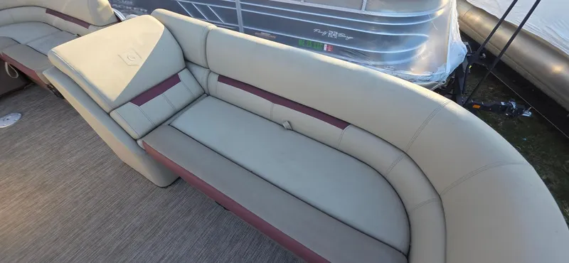 Slide: The Image of 2022 Godfrey Sweetwater 2286 FS boat seating, featuring plush, curved upholstery in a neutral tone. - 5