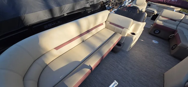 Slide: The Image of 2022 Godfrey Sweetwater 2286 FS boat interior with beige seating and spacious layout. - 6