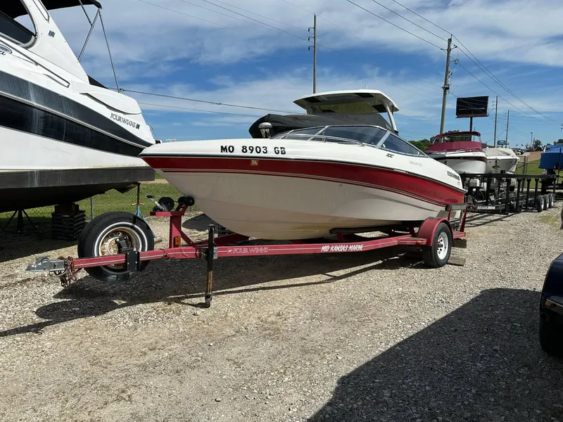 Slide: The Image of 1998 Four Winns 190 Horizon boat on trailer, parked outdoors under a clear sky. - 1