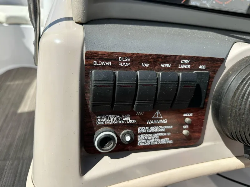Slide: The Image of Control panel of a 1998 Four Winns 190 Horizon boat with various switches. - 13