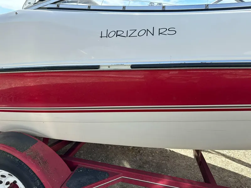 Slide: The Image of 1998 Four Winns 190 Horizon boat with red and white hull on a trailer. - 20